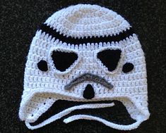 a crocheted hat with a face drawn on it