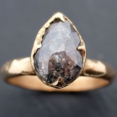 a close up of a gold ring with a stone