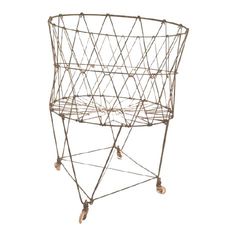 a metal wire basket with wheels on it