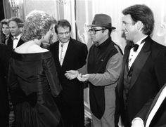 black and white photograph of people in formal wear talking to each other at an event