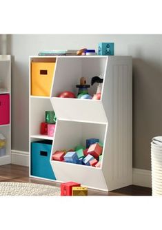 a white book shelf filled with lots of different colored bins and toys on top of it