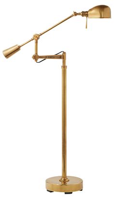 an antique brass desk lamp with a dimmer on the arm and one light turned on