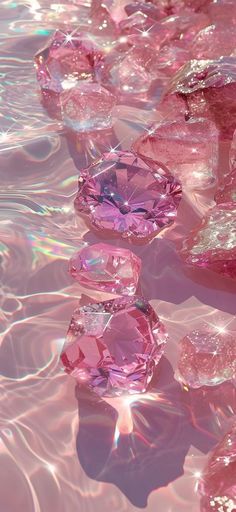 many pink diamonds floating on top of water