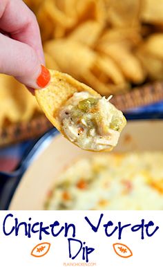 a hand holding a tortilla chip over a bowl of chicken veggie dip