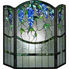 a stained glass window with blue flowers on the outside and green leaves on the inside