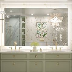 a bathroom with two sinks and a large mirror over it's counter top area