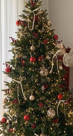 a decorated christmas tree with red and gold ornaments