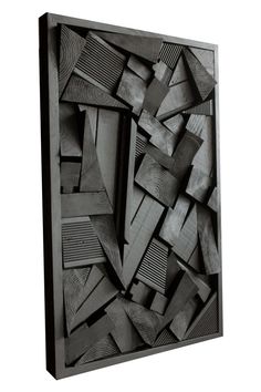 a black and white photo of an abstract art piece with wood pieces in the middle