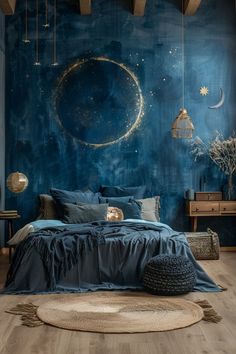 a bedroom decorated in blue and gold with a large moon painted on the wall above the bed