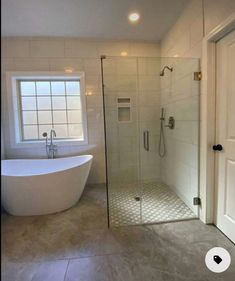 a bathroom with a bathtub, sink and shower in it's center area