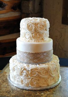 the wedding cake is white and has swirls on it