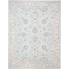 a light blue and white rug with an ornate design