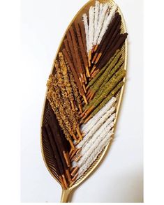 an assortment of different types of spices on a leaf shaped tray with gold trimmings