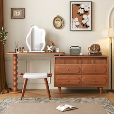 a room with a desk, chair and pictures on the wall above it that is decorated in brown and white