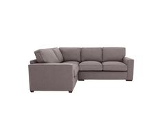 a gray sectional couch sitting on top of a white floor