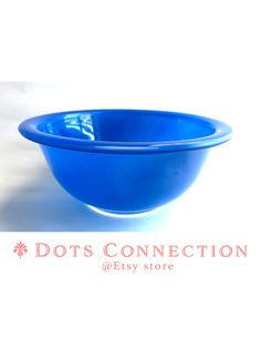 a blue bowl sitting on top of a white table next to the words dots connection