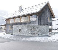 an old stone building with snow on the ground