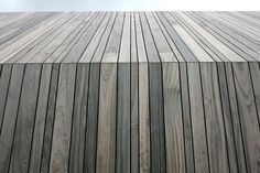 a close up of a wooden floor with sky in the background