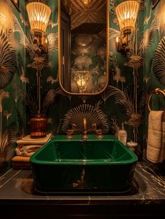 a green sink in front of a mirror with lights above it and towels on the counter