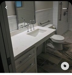 a bathroom with a sink, toilet and shower