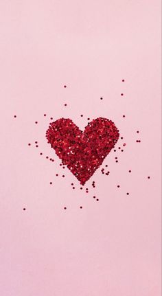 a red heart surrounded by lots of glitter