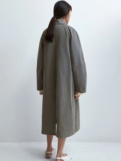 The Cordera Wax Cotton Trench in Taupe Grey is a unique and special rainy trench coat that is light and water repellent. Designed with a relaxed fit and long length, it's a perfect piece for the in-between season. Detailed with covered buttons and two ornamental pockets. 50% cotton / 39% polyester / 16% polyamide Hand wash or dry clean Made in Spain — Cordera, founded by sisters Mónica and María in 2008, has cultivated a distinct identity rooted in minimalism and ethical production practices. Ne Spring Rainy Weather Long Coat, Oversized Solid Color Raincoat For Fall, Oversized Solid Raincoat For Fall, Khaki Outerwear For Rainy Spring Weather, Spring Raincoat With Button Closure For Rainy Weather, Oversized Solid Raincoat For Spring, Long Coat For Workwear In Rainy Season, Solid Color Long Raincoat For Spring, Long Coat For Work During Rainy Season