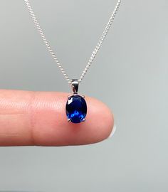 Small Sterling Silver Blue Sapphire CZ Pendant Necklace Simple Necklace/Minimalist Necklace/Elegant Necklace  Dainty and Petite Necklace Perfect For Everyday Wear September Birthstone Necklace  Metal: All components are made from solid .925 Sterling Silver  Stone: Cubic Zirconia Stone size: 8mm x 6mm Pendant Measurement: 13mm x 6mm Choose Chain Length At Checkout  You can find other CZ and Birthstone Jewelry in my shop here   https://www.etsy.com/shop/LinksAndStones?ref=seller-platform-mcnav&section_id=24399452 Please feel free to Convo me with any questions before purchasing.  Please view policy before purchasing Thank You For Visiting My Shop NK0-12 Sapphire Necklace Simple Stone, Sapphire Silver Necklace, Necklace Sapphire Pendant, Blue Oval Birthstone Necklaces, Blue Sapphire Necklace Silver, Blue Oval Birthstone Necklace, Oval Sapphire Jewelry With Stones, Oval Sapphire Stone Jewelry, Blue Birthstone Necklace With Oval Pendant