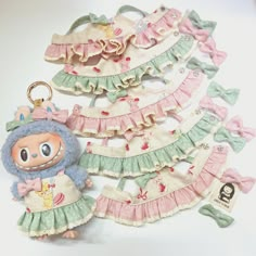 several little doll keychains are arranged on a table