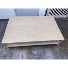 a wooden table sitting on the ground next to a radiator