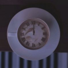 an analog clock on the side of a wall