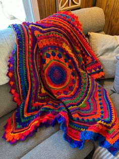 a colorful crocheted blanket on a couch