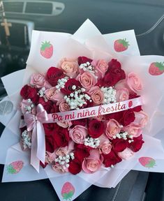 a bunch of flowers that are sitting in the back seat of a car with a ribbon on it