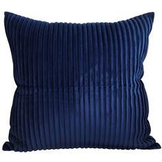 a blue velvet pillow with pleating on the front and back, sitting on a white background