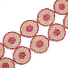 several pieces of woven material with circles on them, all in pink and red colors