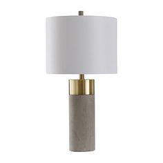 a table lamp with a white shade on the top and gold trim around the base