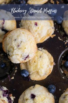 blueberry muffins in a muffin tin with fresh blueberries