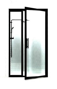 an open shower door in front of a white brick wall with a black handle on it