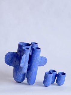 three blue vases sitting next to each other