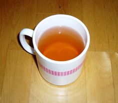 a cup of tea sitting on top of a wooden table