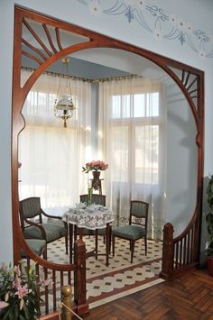 a dining room table and chairs in front of a window