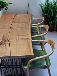 a wooden table sitting next to green chairs