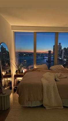 a bedroom with a large window overlooking the city