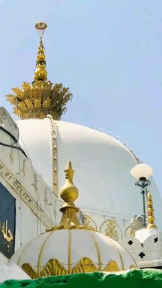 a large white dome with gold decorations on top