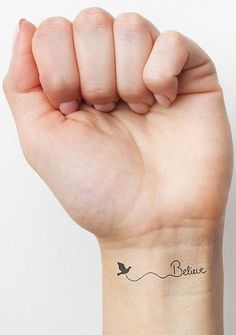 a woman's arm with a small tattoo on the wrist that says, believe