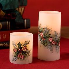 two lit candles sitting next to each other on a table