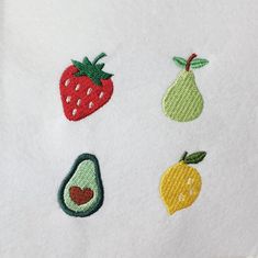 embroidered fruit and vegetable appliques on white fabric