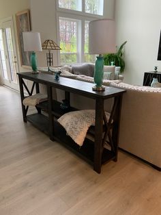 a living room filled with furniture and a flat screen tv on top of a wooden table