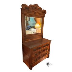 a wooden dresser with a mirror above it