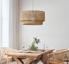 a dining room table and chairs with a plant in the center on top of it