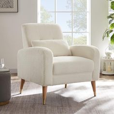 a white chair sitting in front of a window